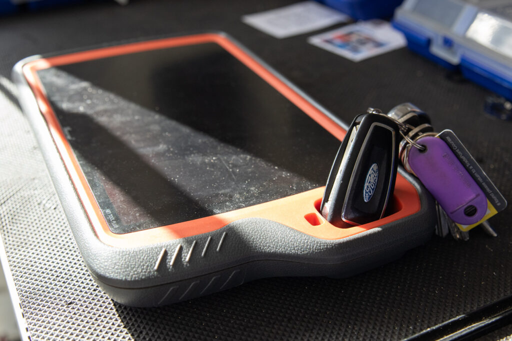 A Ford car key inserted into digital key programming device during a mobile key fob programming service by AH Locktech