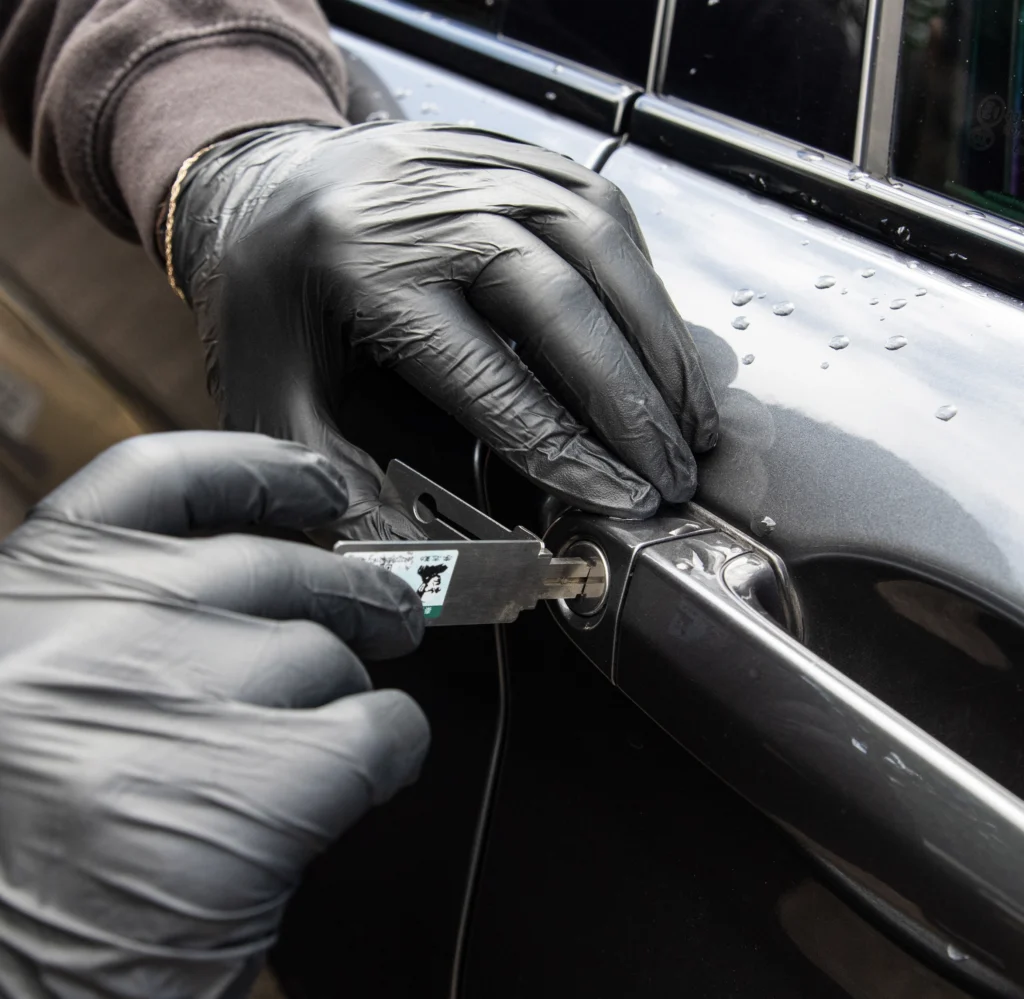 A BMW door lock being unlocked using non-destructive methods.